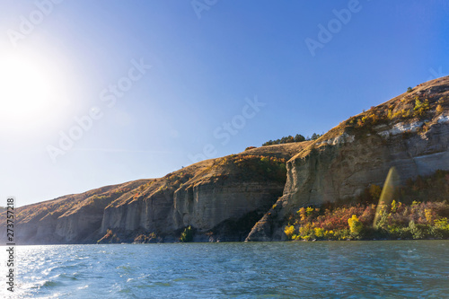 beautiful rocky coast of the river with autumn trees. view from