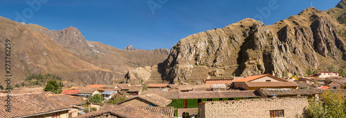 Top panoramic view of the inca town of Ollantaytambo with it's adobe houses, with the archaeological site on the background and the valley. Beautiful travel destination in the Sacred Valley, Peru photo