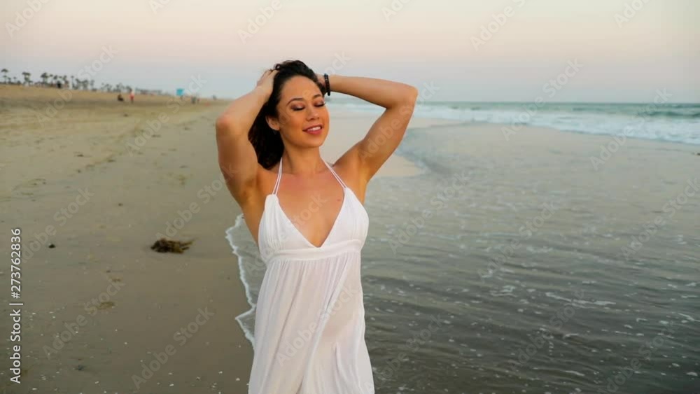 Beautiful woman enjoying the beach at sunset. Beautiful woman enjoying the beach at sunset.