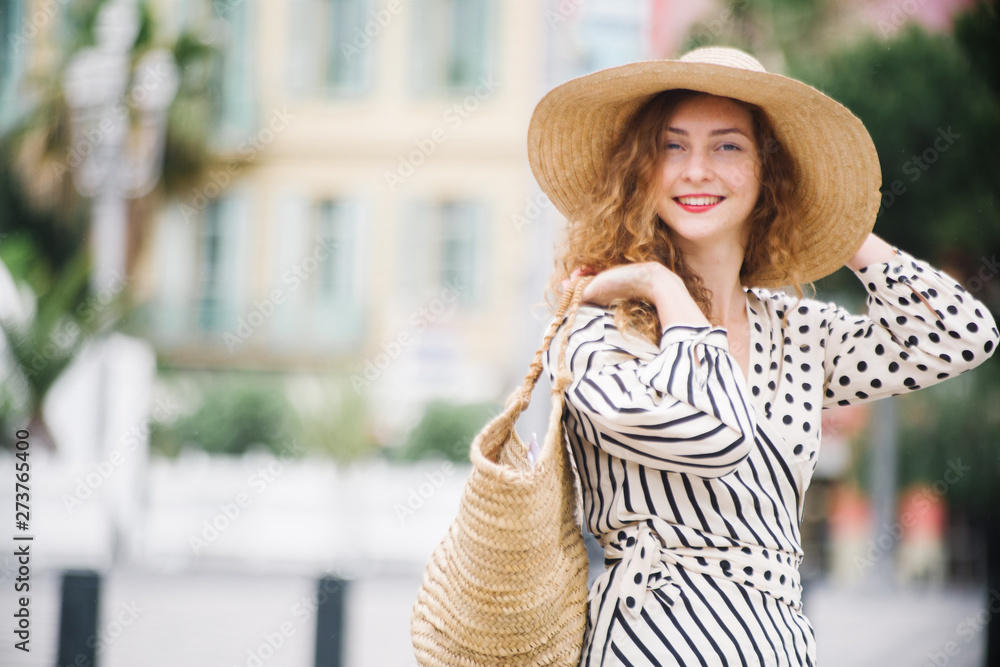 Young caucasian teenager with hat, traveling and loving the french riviera and nice city, fresh face, clean blurred backgorund.