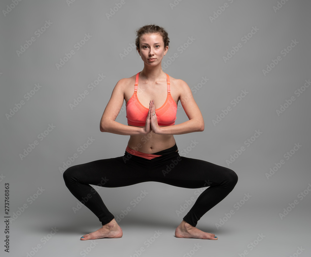 Obraz premium The young woman makes yoga exercises