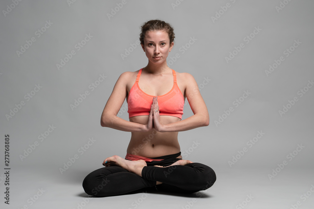 The young woman makes yoga exercises