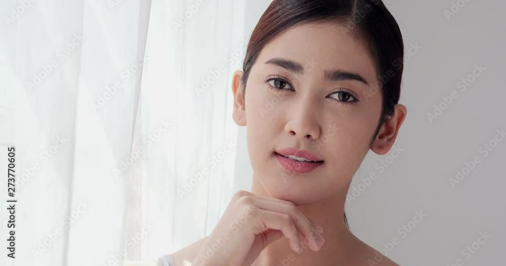 Beautiful asian woman looking to camera and touch her face. Beautiful asian woman looking to camera and touch her face.