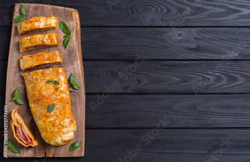 Fényképezés Pizza roll stromboli with cheese salami olives and tomatoes