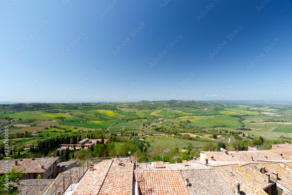 Looking out over the rooftops of Pienza, Tuscany, Italy, towards the open valley filled with small farms
