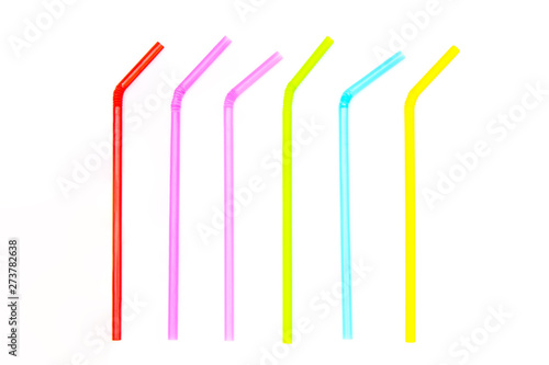 Pile of colorful plastic drinking straws isolated on white background.