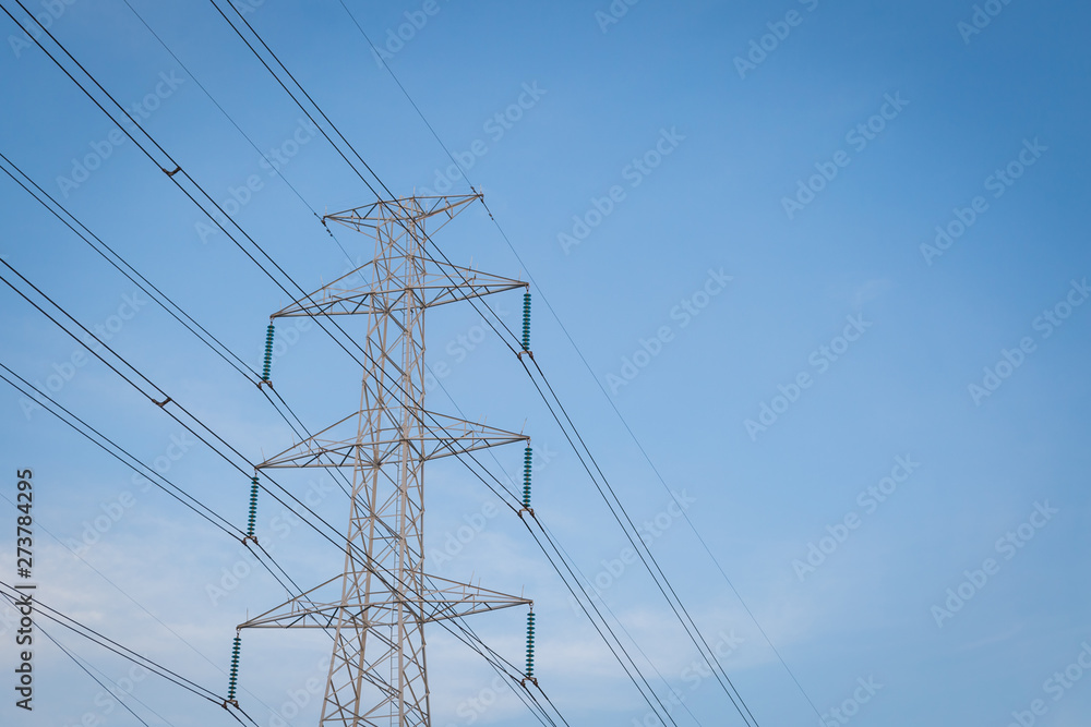 High voltage post tower with blue sky before sunset
