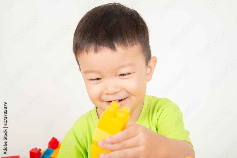 Little boy toddler playing plastic brick block colorful with happy Little boy toddler playing plastic brick block colorful with happy