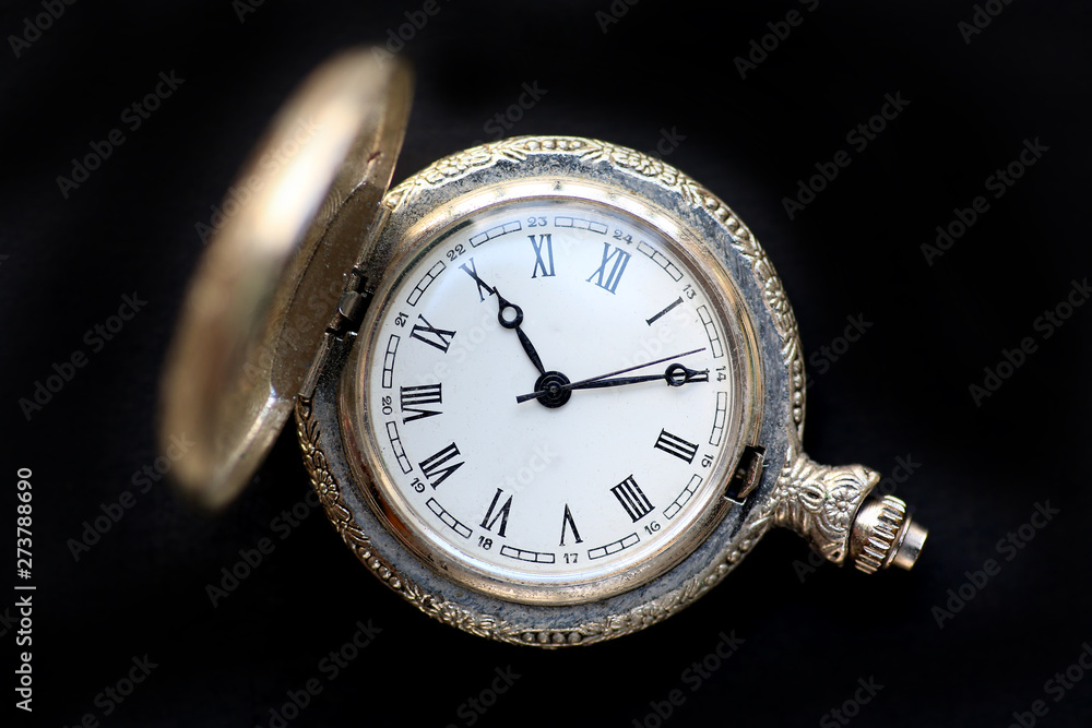 Close up pocket watch on black background Close up pocket watch on black background