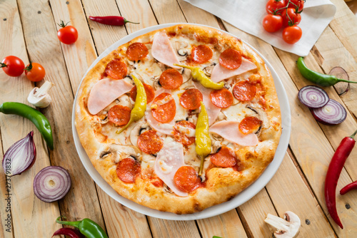 tasty pizza on the wooden background