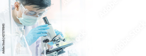 Researcher carrying out scientific research in the lab. Test tubes with liquid in laboratory, Doctor hand holding dropper with dripping transparent glass pipette. scientist for size text space.