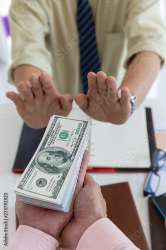 Business and finance concept, Hand of a businessman refuse money from his partner. photo