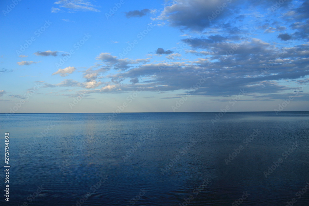 spring sea lake and blue sky and clouds sunset