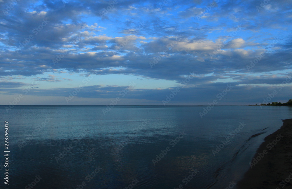 Fototapeta premium spring sea lake and blue sky and clouds sunset