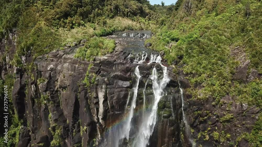 New Zealand Drone pull back reveal shot of waterfall and rainbow New Zealand Drone pull back reveal shot of waterfall and rainbow