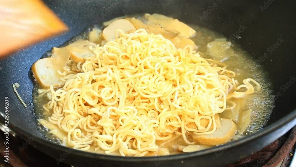 Frying noodles and fish lines with garlic chives in pan, Chiangmai Thailand Frying noodles and fish lines with garlic chives in pan, Chiangmai Thailand