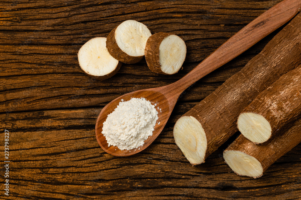 Raw Cassava. Pieces of Manihot esculenta. Wooden background old