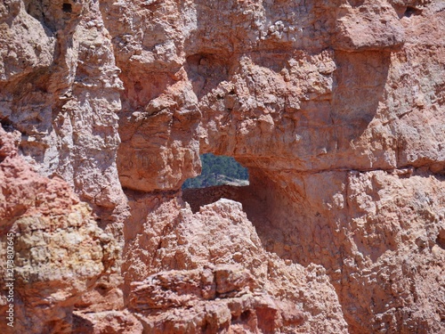 Amazing cave-like hole in a red rock wall at at Black Birch Canyon, Bryce Canyon National Park in Utah.