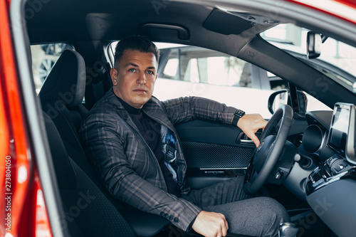 Attractive elegant happy man in good res car