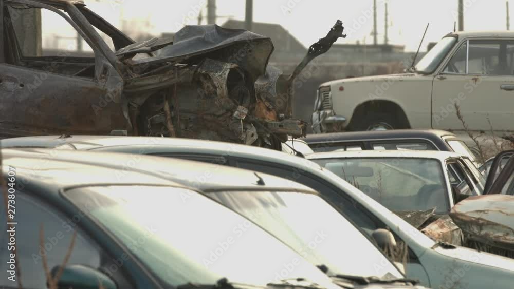 Crushed corroded old cars stacked in scrapyard. Junkyard Crushed corroded old cars stacked in scrapyard. Junkyard