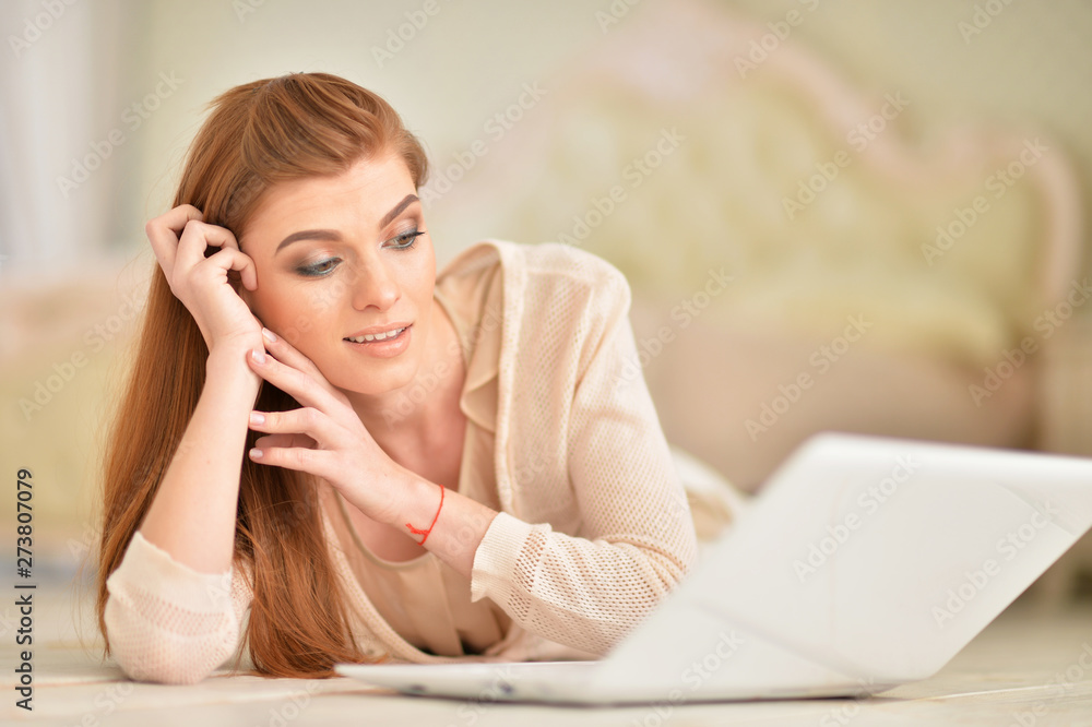 Beautiful young woman lying on wooden floor Beautiful young woman lying on wooden floor