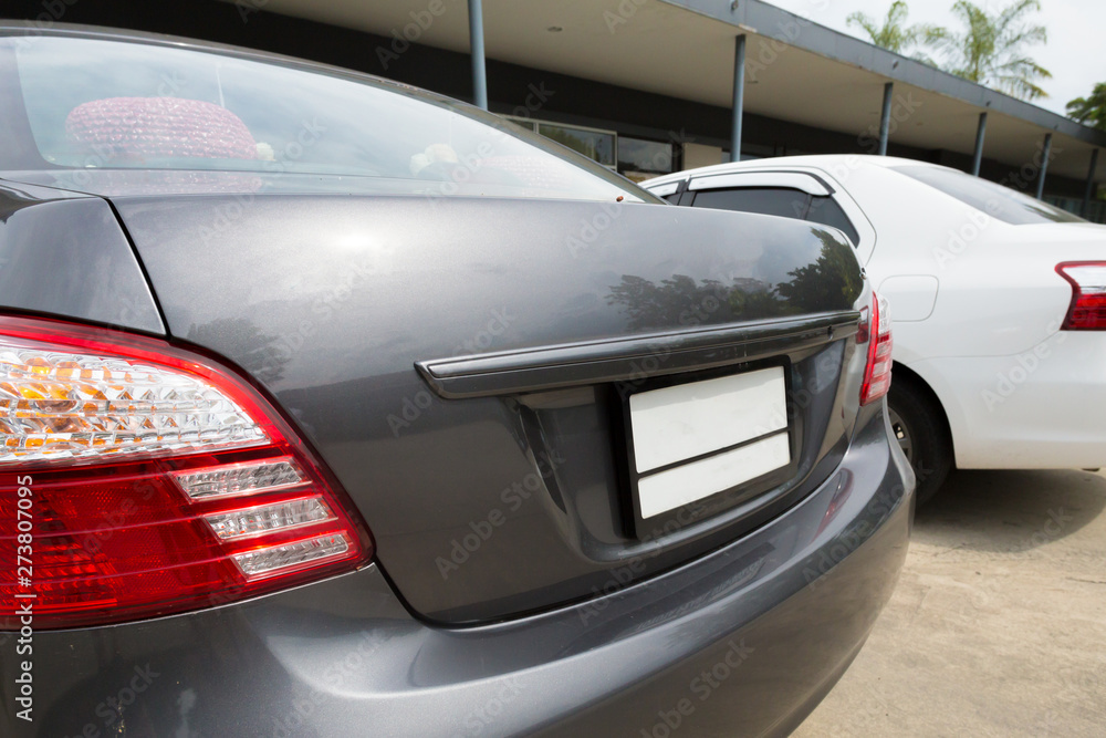 Close up back of 2 cars parking on the road