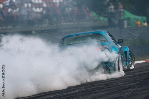 Vászonkép Sport car in motion with a lot of smoke
