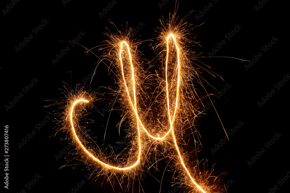 Sparkle firework writing sign/symbol on black background