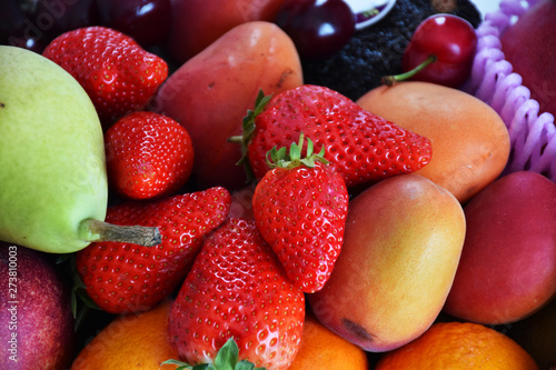 Fototapeta Naklejka Na Ścianę i Meble -  top view of assorted fruit strawberries cherries pear orange and apricot