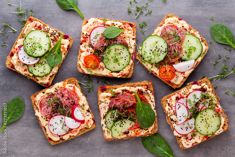 Sandwiches with cream cheese, vegetables and salami. Sandwiches with cream cheese, vegetables and salami.