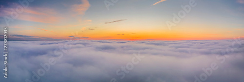 Beautiful misty dawn. Flying above the clouds, drone video