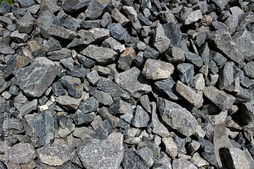 Pieces of granite of different shapes folded into a pile.