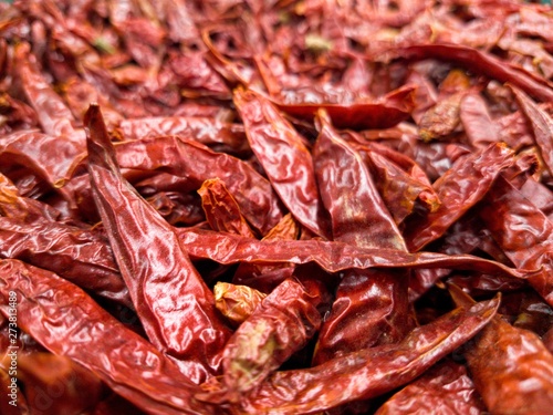  Dried red pepper that is stacked together in a super maket