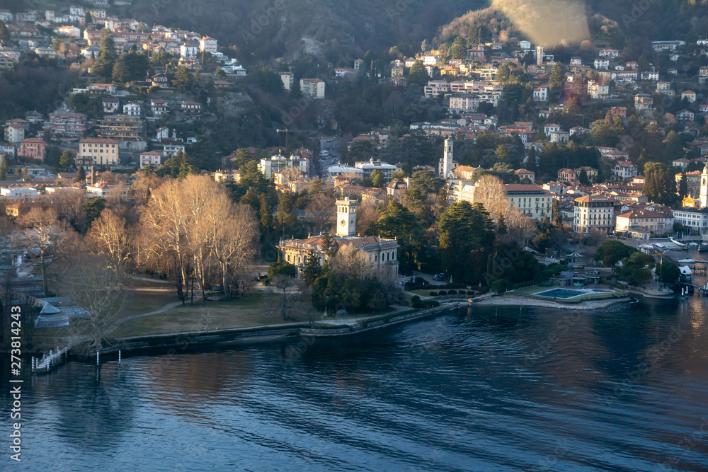 The coast of Lake Como at golden hour. The view from the window of a light aircraft. Como, Italy.