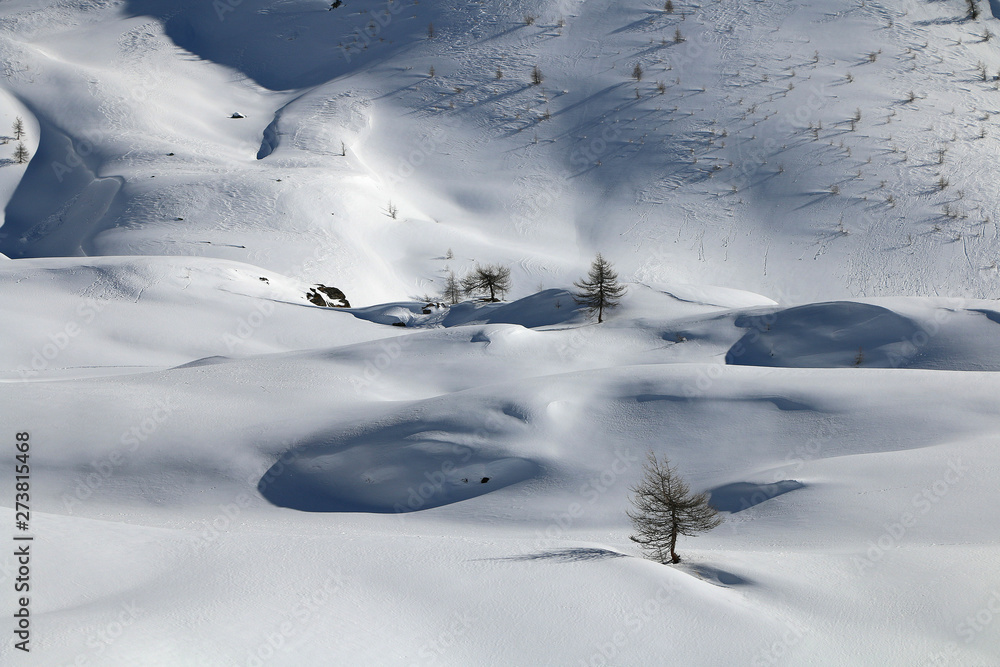 Italian Alps, Valle d'Aosta, Italy. Beautiful alpine snowy landscape in a sunny winter day.