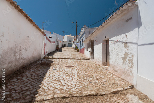 White house in small town of south Portugal with narrow streets and under blue sky. Sunny village of Algarve region © radiokafka