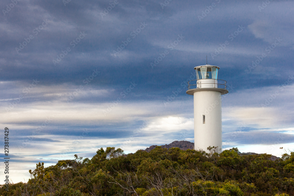 Cape Tourville lighthouse, Freycinet National Park, Tasmania, Australia, rests again as maritine vessels are sae and another day dawns.