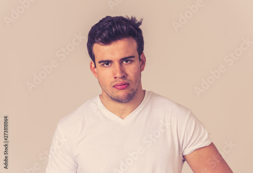 Young attractive latin man with angry facial expression