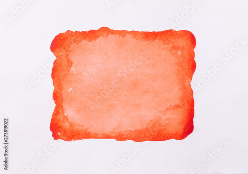 Trend photo on the theme of fashionable orange hue this season. Bright smear of watercolor paint on a white paper background.