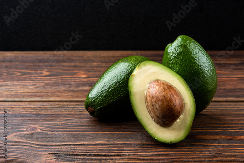 Avocado on dark wooden background.