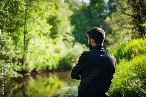 Silhouette of a man from the back at sunset. The male model back to nature