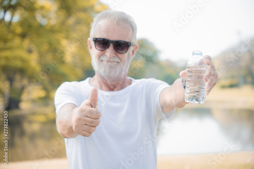portrait of a older man show thumbs up for drinking a water is best after exercies in morning