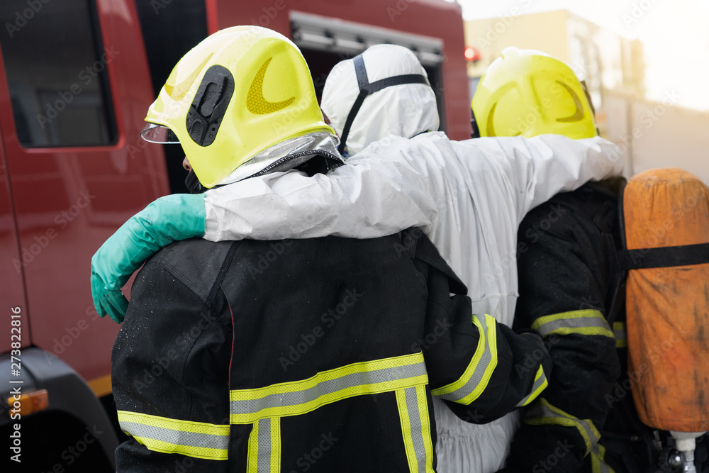 Fototapeta premium firefighter help and carry victim people from disaster out danger area