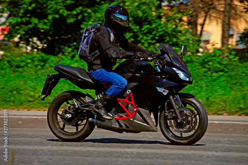 Fototapeta Naklejka Na Ścianę i Meble -  motorcycle racer driving at high speed on highway