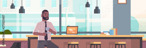 businessman sitting on chair at bar counter with laptop coffee break concept african american business man drinking cappuccino modern cafe interior flat portrait horizontal