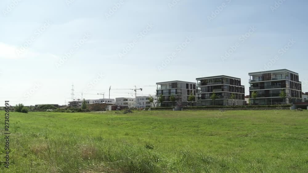 Row of Newly Built Low Rise Apartment Buildings from Grass Field Row of Newly Built Low Rise Apartment Buildings from Grass Field