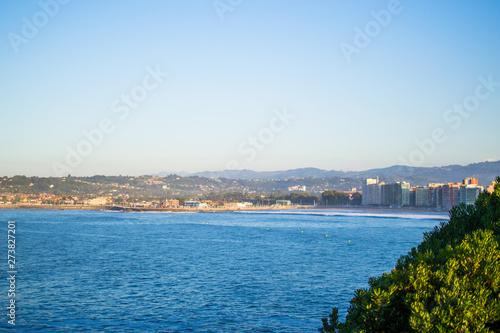 View of Gijon and Cantabrian Sea from Cerro de Santa Catalina, in Asturias, Spain. Green park and hill