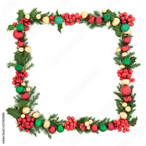 Christmas background square border with red, green and gold bauble decorations, with winter holly and juniper fir leaves on white background with copy space. Festive decoration.