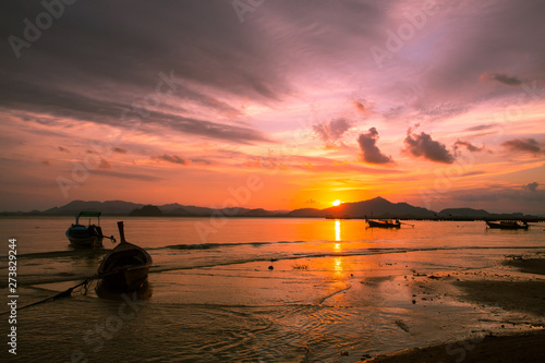 Silhouette of beautiful sunset with fishing boat © Morakot