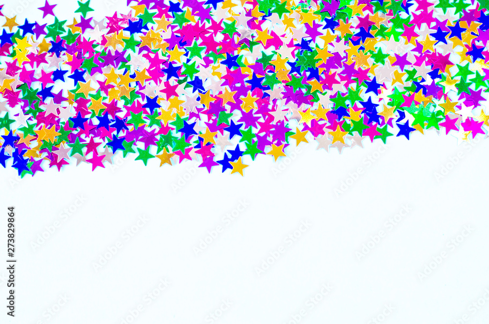 Many multicolored confetti stars on a white background.
